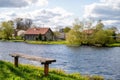 Wooden bench on the bank of the river. Spring landscape Royalty Free Stock Photo