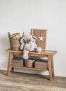 Wooden bench, basket with blankets, stuffed elephant toy in the interior of the children`s room