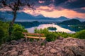 Wooden bench and beautiful view with lake Bled at sunset Royalty Free Stock Photo