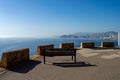 Wooden bench on a Benidorm viewpoint with a beautiful view of the blue sea Royalty Free Stock Photo