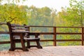 Wooden bench on a bridge over a lake Royalty Free Stock Photo