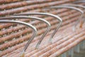 Wooden bench chair with iron handle in the park close up. Selective focus Royalty Free Stock Photo