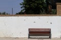 Wooden bench with a chipped wall in the background with space for texts, copy space Royalty Free Stock Photo