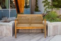 Wooden bench in the city park. Recreation area with empty contemporary wooden benches. Public city resting area design Royalty Free Stock Photo