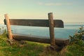 Wooden bench on cliff edge
