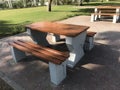 Wooden bench with concrete supports built in between the interlock floor tile flooring for a healthy and relax