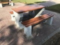 Wooden bench with concrete supports built in between the interlock floor tile flooring for a healthy and relax