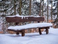 Wooden bench covered by snow. Royalty Free Stock Photo