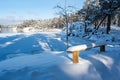 Wooden bench covered in snow near lake Vattern Motala Sweden
