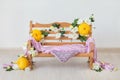 A wooden bench decorated with yellow and white chrysanthemums flowers