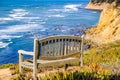 Wooden Bench on the Edge of a Cliff, Pacific Ocean coastline, Moss Beach, California Royalty Free Stock Photo