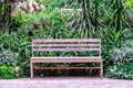 Wooden bench among the flower garden Royalty Free Stock Photo