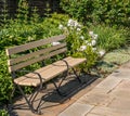 A wooden bench in a flower garden in city owned Mellon Park in Pittsburgh, Pennsylvania, USA Royalty Free Stock Photo