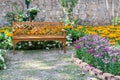 Wooden bench in the flower garden Royalty Free Stock Photo