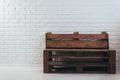 Wooden bench of flying against a white brick wall Royalty Free Stock Photo