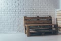 Wooden bench of flying against a white brick wall Royalty Free Stock Photo