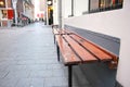 Wooden bench on footpath