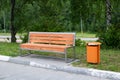 Wooden bench and garbage can in the park Royalty Free Stock Photo