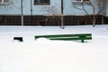 Wooden bench in winter under the snow, inaction of snow blowers in the snowfall