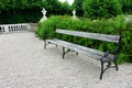 Wooden bench in a green park with shrubs Royalty Free Stock Photo