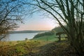 Wooden bench on a hill with outlook on the river trave in the mo Royalty Free Stock Photo