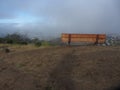 Wooden Bench On Hillside In The Fog