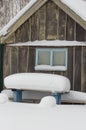 wooden bench at the house under the snow in winter Royalty Free Stock Photo