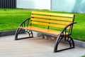 Wooden bench with iron black legs.