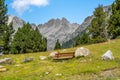 Wooden bench located on a mountain in the Pyrenees with a spectacular panoramic view of the mountains and a green meadow Royalty Free Stock Photo