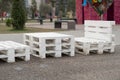 Wooden bench made of pallets of freight cargo cases for sitting. Creative outdoor cafe table and benches.