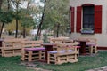 Wooden bench made of pallets for sitting with tables made from coil of electric cable Royalty Free Stock Photo