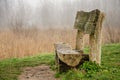 Wooden bench on a misty morning