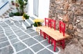 Wooden bench on narrow street in Naussa, Paros Royalty Free Stock Photo