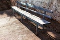 Wooden bench near wall Royalty Free Stock Photo