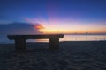 Wooden bench over beautiful tropical beach and magical twilight