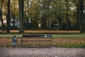 Wooden bench in a park on a cold autumn day Royalty Free Stock Photo