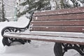 wooden bench in the park covered with snow. winter in the park Royalty Free Stock Photo