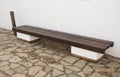 Wooden bench in the park near the wall Royalty Free Stock Photo