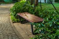 Wooden bench in the park at night with green tree surrounding Royalty Free Stock Photo