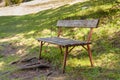 Wooden bench in the park in summer sunset Royalty Free Stock Photo