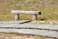 Wooden bench at path leading through dunes at Nagliai nature reserve Royalty Free Stock Photo