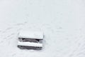 Wooden bench picnic table in a park covered with snow Royalty Free Stock Photo