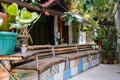 Wooden bench with plants and flower pots in tropical patio, Asia, Philippines. Terrace decoration in asian village.