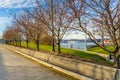 Wooden Bench in a Riverside Park at Sunset Royalty Free Stock Photo