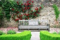 Wooden bench in the rose gardens of Lismore castle Royalty Free Stock Photo