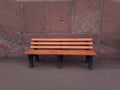 Wooden bench in the sidewalk Royalty Free Stock Photo