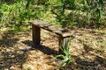 A wooden bench sitting in the woods