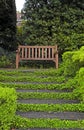 Wooden bench and staircase in garden Royalty Free Stock Photo