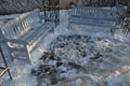 wooden bench on stone gray pavement in the park with Royalty Free Stock Photo