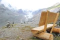 Wooden bench and stone stacks with a view of bare snow mountains